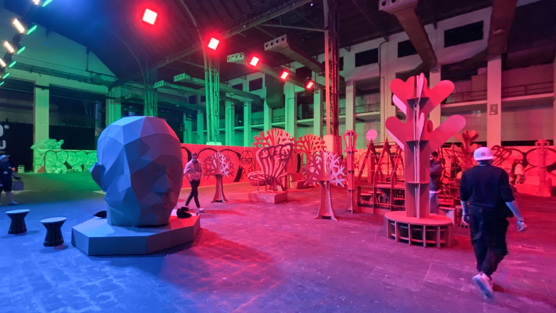 Cabeza de cartón junto a muebles para eventos.